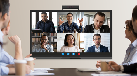 Office workers in a meeting room during a conference call.