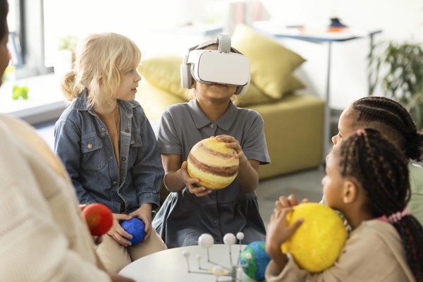 Children learning about the solar system through a VR headset.